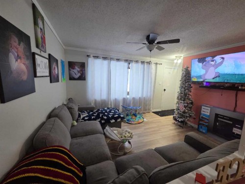 9306 106 Avenue, Grande Prairie, AB - Indoor Photo Showing Living Room With Fireplace