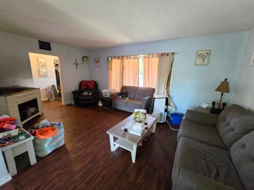 8602 95 Street, Peace River, AB - Indoor Photo Showing Living Room With Fireplace