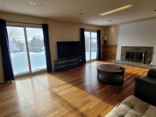 7110 99A Street, Peace River, AB - Indoor Photo Showing Living Room With Fireplace