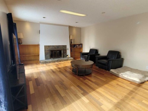 7110 99A Street, Peace River, AB - Indoor Photo Showing Living Room With Fireplace