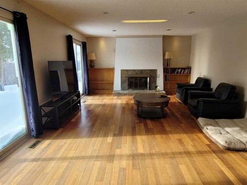 7110 99A Street, Peace River, AB - Indoor Photo Showing Living Room With Fireplace