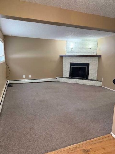 101-11114 Hoppe, Grande Cache, AB - Indoor Photo Showing Other Room With Fireplace