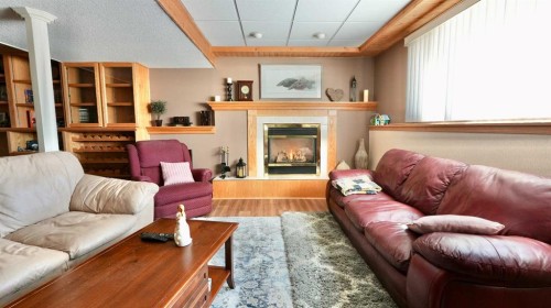 8101 95 Street, Peace River, AB - Indoor Photo Showing Living Room With Fireplace