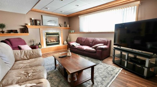 8101 95 Street, Peace River, AB - Indoor Photo Showing Living Room With Fireplace