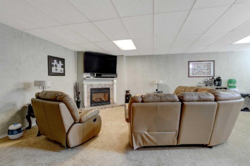 308 11Th Avenue, Beaverlodge, AB - Indoor Photo Showing Basement With Fireplace