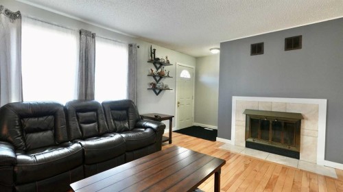 9610 77 Avenue, Peace River, AB - Indoor Photo Showing Living Room With Fireplace