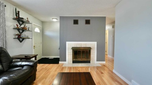9610 77 Avenue, Peace River, AB - Indoor Photo Showing Living Room With Fireplace