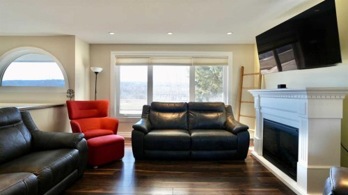 7901 94 Street, Peace River, AB - Indoor Photo Showing Living Room With Fireplace