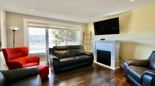 7901 94 Street, Peace River, AB - Indoor Photo Showing Living Room With Fireplace