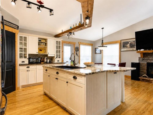 14-71332 Range Road 262, Ridgevalley, AB - Indoor Photo Showing Kitchen With Fireplace