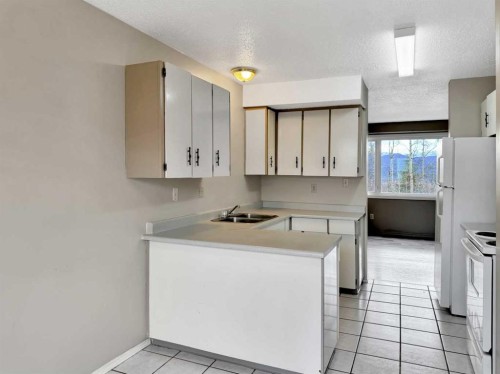 57 97 Avenue, Grande Cache, AB - Indoor Photo Showing Kitchen With Double Sink