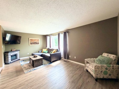 53 97 Avenue, Grande Cache, AB - Indoor Photo Showing Living Room With Fireplace