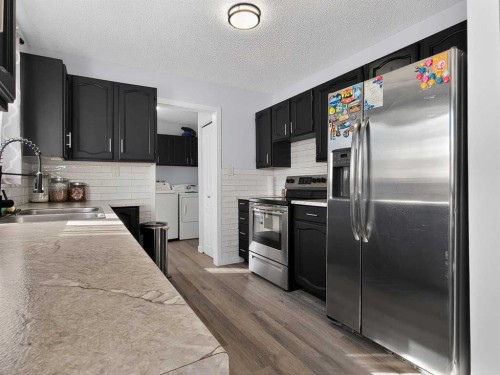 9704 94 Avenue, Wembley, AB - Indoor Photo Showing Kitchen With Stainless Steel Kitchen With Double Sink