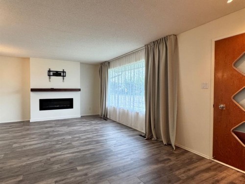 10713 105 Avenue, Fairview, AB - Indoor Photo Showing Living Room With Fireplace