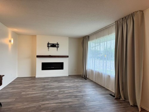 10713 105 Avenue, Fairview, AB - Indoor Photo Showing Living Room With Fireplace