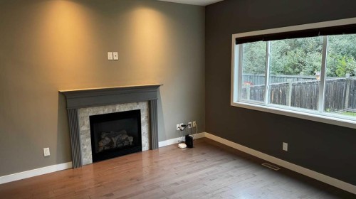 8105 112 Street, Grande Prairie, AB - Indoor Photo Showing Living Room With Fireplace