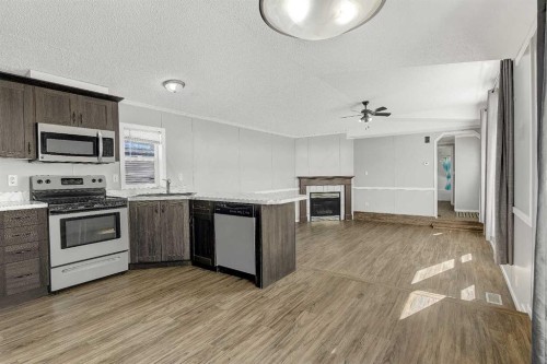 12128 98 Street, Grande Prairie, AB - Indoor Photo Showing Kitchen With Fireplace