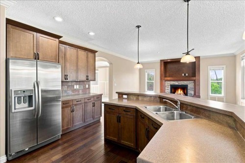 9335 Lakeshore Court, Grande Prairie, AB - Indoor Photo Showing Kitchen With Fireplace With Double Sink