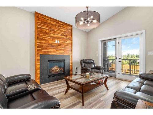 56 Hamptons Crescent Se, Medicine Hat, AB - Indoor Photo Showing Living Room With Fireplace