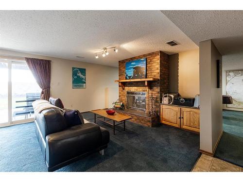 594 Ross Glen Drive Se, Medicine Hat, AB - Indoor Photo Showing Other Room With Fireplace