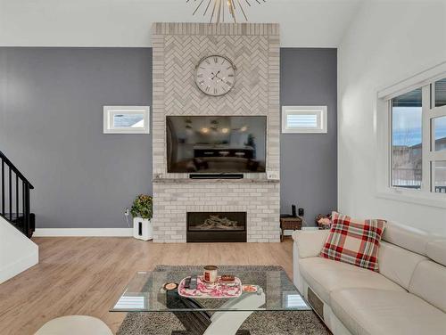 7 Sterling Green Se, Medicine Hat, AB - Indoor Photo Showing Living Room With Fireplace
