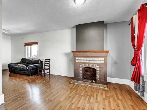 27 4 Street Sw, Medicine Hat, AB - Indoor Photo Showing Living Room With Fireplace