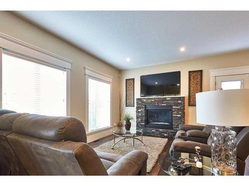 2 Desert Blume Close Sw, Desert Blume, AB - Indoor Photo Showing Living Room With Fireplace