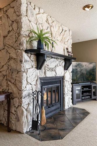 2-1165 16 Street Ne, Medicine Hat, AB - Indoor Photo Showing Other Room With Fireplace