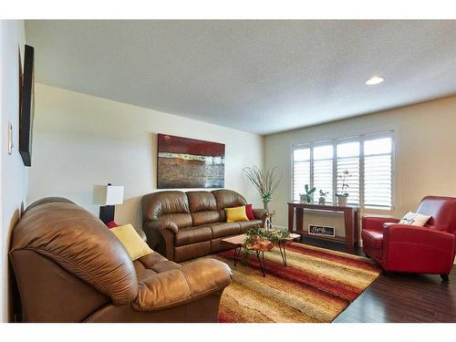 319 Hamptons Way Se, Medicine Hat, AB - Indoor Photo Showing Living Room With Fireplace