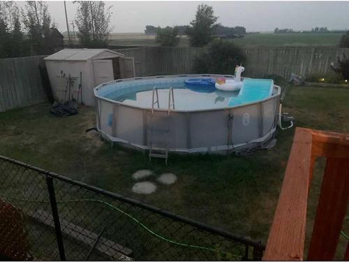 109 Westview Crescent West, Bow Island, AB - Outdoor With Above Ground Pool With Backyard