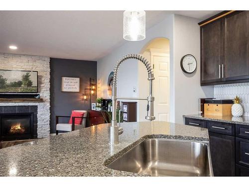 255 Hamptons Way Se, Medicine Hat, AB - Indoor Photo Showing Kitchen With Fireplace