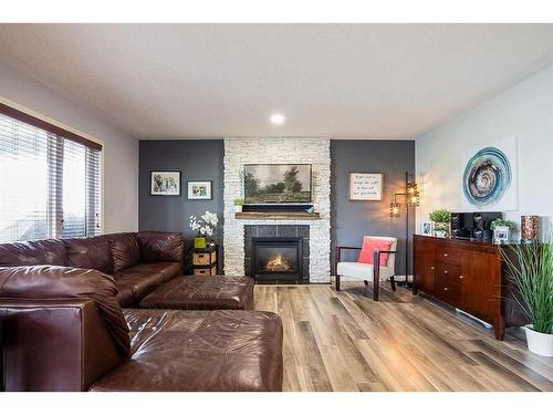 255 Hamptons Way Se, Medicine Hat, AB - Indoor Photo Showing Living Room With Fireplace
