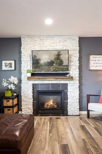 255 Hamptons Way Se, Medicine Hat, AB - Indoor Photo Showing Living Room With Fireplace