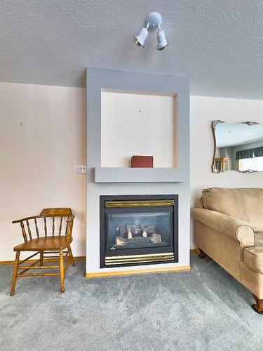 229-1182 Southview Drive Se, Medicine Hat, AB - Indoor Photo Showing Living Room With Fireplace