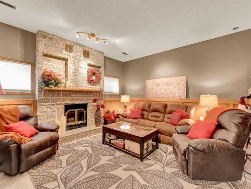 57 Shaw Crescent Se, Medicine Hat, AB - Indoor Photo Showing Living Room With Fireplace