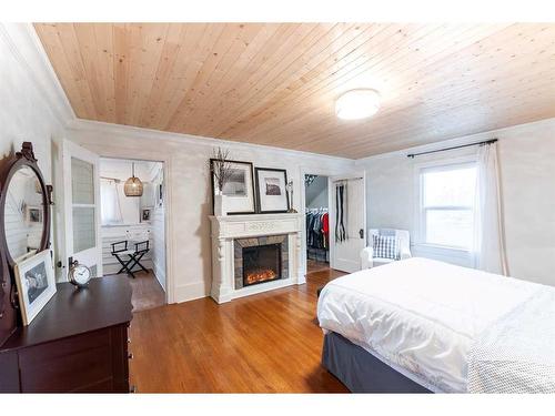 38 4 Street Nw, Medicine Hat, AB - Indoor Photo Showing Bedroom With Fireplace