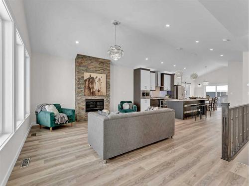 33 Dunes Way, Desert Blume, AB - Indoor Photo Showing Living Room With Fireplace