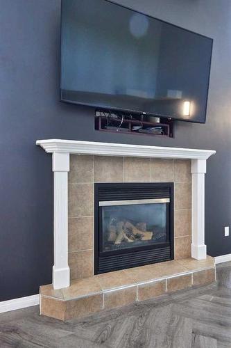 23 Sunrise Court Sw, Medicine Hat, AB - Indoor Photo Showing Living Room With Fireplace