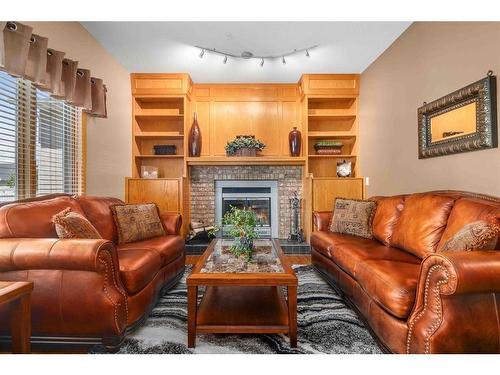 687 Ross Glen Drive Se, Medicine Hat, AB - Indoor Photo Showing Living Room With Fireplace