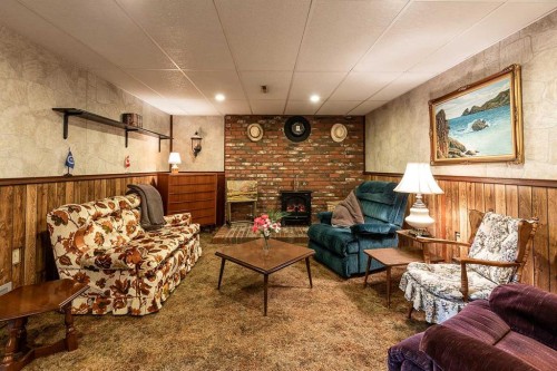 242 11Th Street Ne, Medicine Hat, AB - Indoor Photo Showing Living Room With Fireplace