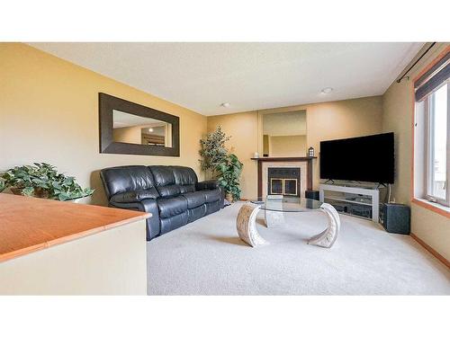 19 Calder Green Se, Medicine Hat, AB - Indoor Photo Showing Living Room With Fireplace