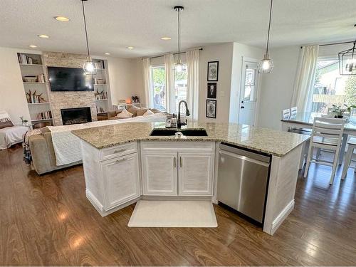 938 Manor Place, Redcliff, AB - Indoor Photo Showing Kitchen With Fireplace With Double Sink With Upgraded Kitchen