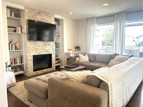 938 Manor Place, Redcliff, AB - Indoor Photo Showing Living Room With Fireplace