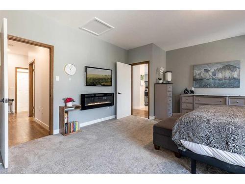 67 Vintage Meadows Place Se, Medicine Hat, AB - Indoor Photo Showing Bedroom With Fireplace