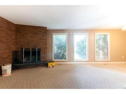 55 Markwick Drive Se, Medicine Hat, AB - Indoor Photo Showing Living Room With Fireplace