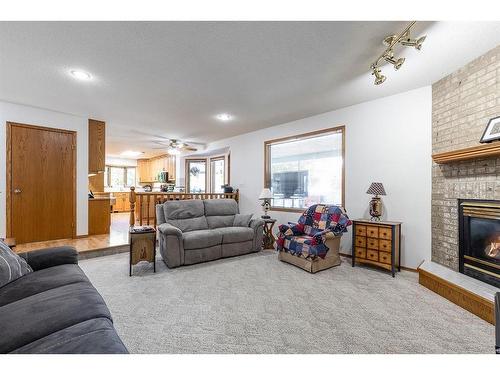 23 Taylor Close Se, Medicine Hat, AB - Indoor Photo Showing Living Room With Fireplace