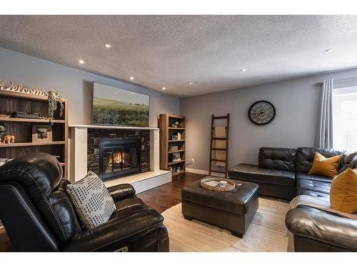 15 Ross View Close Se, Medicine Hat, AB - Indoor Photo Showing Living Room With Fireplace