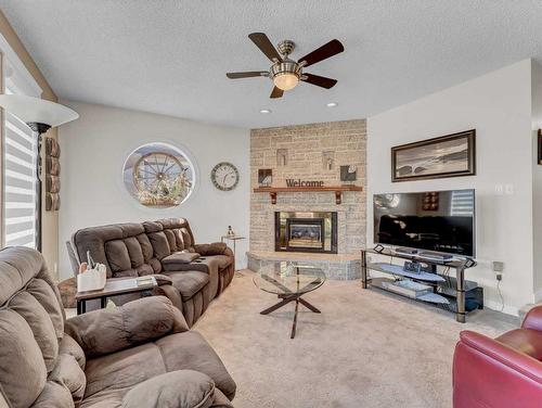 232 Ross Glen Road Se, Medicine Hat, AB - Indoor Photo Showing Living Room With Fireplace