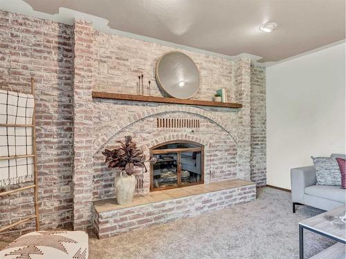 6 Ross Heights Place Se, Medicine Hat, AB - Indoor Photo Showing Living Room With Fireplace