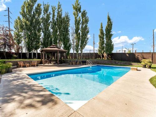 74 Terrace Court Ne, Medicine Hat, AB - Outdoor With In Ground Pool With Backyard